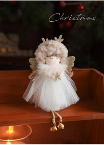 Detail of plush Christmas angel ornament featuring gold antlers and white mesh tutu skirt