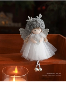 Close-up of plush angel doll with deer antlers, mesh skirt and silver bells detail