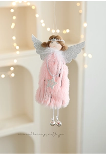 Detail of pink plush Christmas angel doll with silver wings and bells for holiday decor