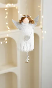 Close-up of white plush angel ornament with sequin wings, bells and heart details