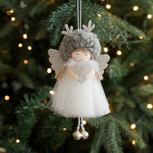 Christmas angel girl doll pendant with silver antlers and bells on a warm glowing tree
