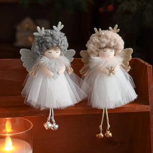 Christmas plush angel ornaments with glitter antlers and bells on wooden shelf