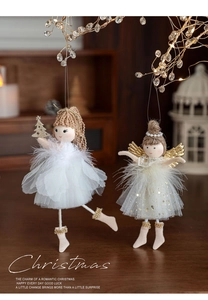 Close-up of plush Christmas angel dolls with soft feathers, mesh skirts and golden wings