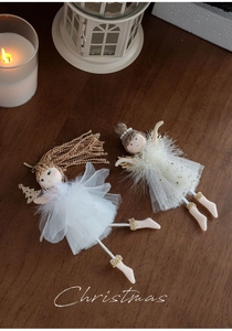 Detail of plush Christmas angel ornaments with lace skirts and golden glitter wings