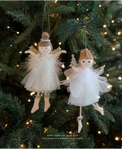 Close-up of plush angel dolls with sequin gauze and feather wings on Christmas tree