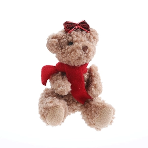 Cute brown curly plush teddy bear with a red glitter bow and scarf for Christmas decor