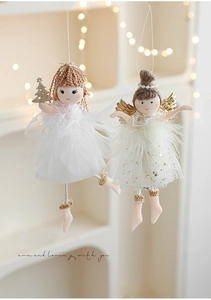 Detail of plush Christmas angel ornaments with white feathers, lace veils and golden wings