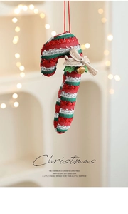 Detail of sequined Christmas candy cane ornament with burlap bow and golden bell
