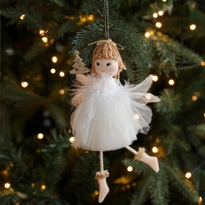 Plush Christmas angel girl ornament with mesh skirt hanging on a decorated tree