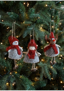 Detailed view of plush Christmas ornaments with red scarves hanging on a festive tree