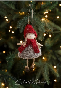 Detail of Christmas elf plush pendant with red felt hat and bells on festive tree