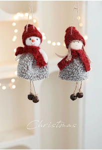 Detail of plush Christmas ornaments with red scarves, knitted texture and rustic metal bells