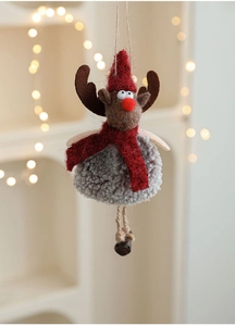 Close-up of plush reindeer ornament with red scarf, felt hat and small metal bell