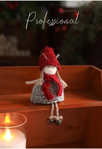 Detailed close-up of handmade Christmas doll with red scarf and vintage metal bells