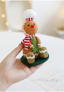 Close-up of a gingerbread man doll with chef hat and scarf for Christmas decor