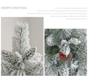 Detail of flocked Christmas tree branches with red berries and natural pine cones