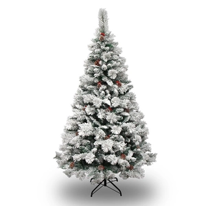 Lush snow-flocked Christmas tree with red berries and pine cones on a sturdy metal stand
