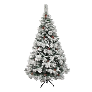 Flocked snowy Christmas tree with red berries and natural pinecones on a black metal stand