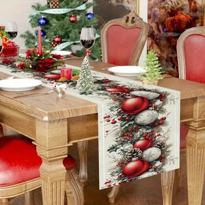 Christmas table runner with red ornaments and pine cones on a wooden dining table