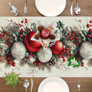 Detailed view of linen Christmas table runner featuring pine branches and red berries