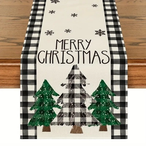 Detail of Christmas table runner with buffalo plaid border and festive tree prints
