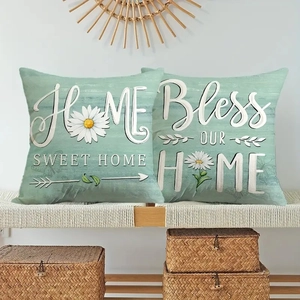 Set of two daisy linen pillow covers with Home Sweet Home print on a wooden bench
