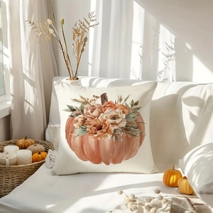 Detail of linen pumpkin pillowcase with fall flowers on a cozy white sofa setting