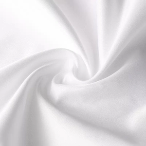 Macro detail of white decorative pillowcase showing soft silk-like fabric texture and sheen