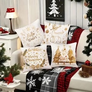 Set of 4 Christmas peach skin pillow covers with gold elk and tree prints on a sofa