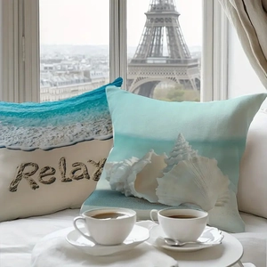 Detail of beach themed throw pillow cases with shells and Relax text in a cozy setting