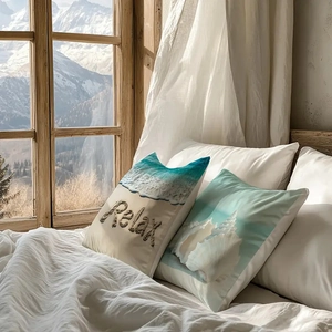 Detail of nautical themed pillowcases featuring Relax text and seashell prints on white bedding