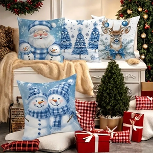 Close-up of four Christmas pillow covers with snowman and reindeer in a cozy setting