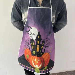 Detail of Halloween apron featuring pumpkins, bats, and castle print on purple fabric