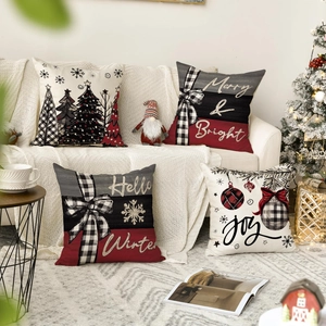 Detail of four linen Christmas pillow covers with rustic snowmen and plaid holiday patterns