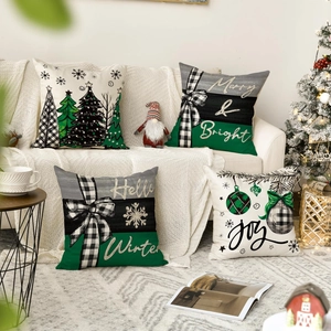 Close-up of four Christmas linen pillow covers with festive snowman and tree prints