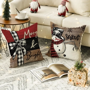Close-up of Christmas linen pillowcases with Merry & Bright text and snowman design