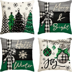 Detail of four Christmas linen pillowcases with snowmen, trees, and festive patterns