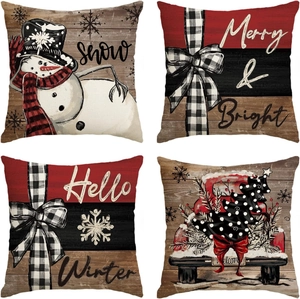 Close-up of linen Christmas pillow covers featuring snowmen and red truck patterns