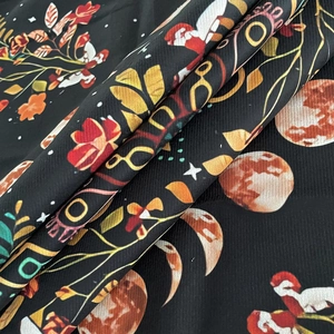 Macro detail of tarot cloth fabric featuring moon phase, floral motifs, and mystical prints