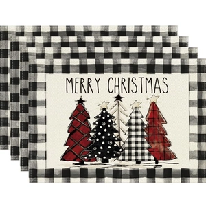 Set of 4 Christmas linen placemats featuring festive trees and black white plaid borders