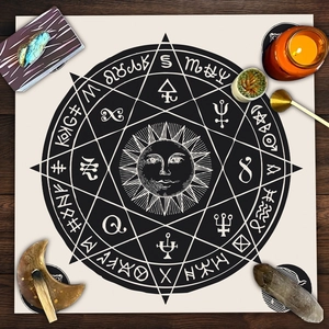 Round tarot altar cloth featuring sun mandala and celestial runes on dark wood background