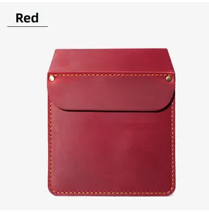 Detail view of red leather pocket holster with orange stitching and metal rivets