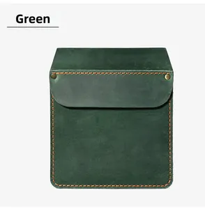 Macro view of green leather tool holster featuring orange stitching and brass rivets