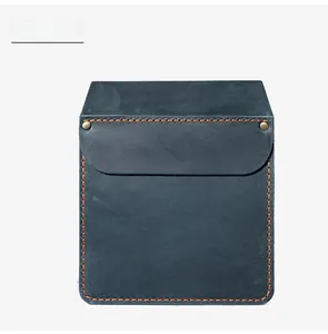 Detail view of blue leather tool pouch with orange double stitching and brass rivets