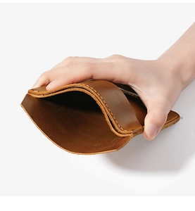 Close-up of flexible brown leather pocket holster showing interior space and stitching
