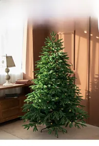 Detailed view of luxury PE mix Christmas tree with warm LED lights and metal stand