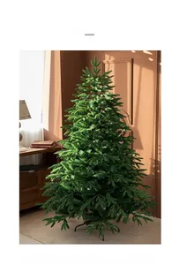 Detail of lush green artificial Christmas tree with dense branches and sturdy metal stand
