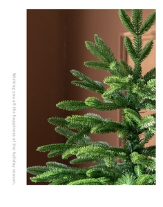Close-up of lifelike dark green artificial Christmas tree needles with dense texture