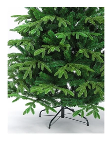 Detailed macro view of lush green PE mixed leaves and sturdy black metal base of Christmas tree