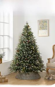 Close-up of a lit Christmas tree featuring warm LED lights, red berries and pine cones
